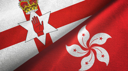 Naklejka premium Northern Ireland and Hong Kong two flags textile cloth, fabric texture