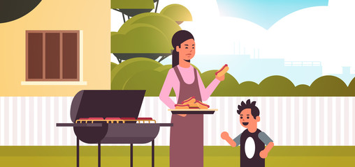 mother and son preparing hot dogs on grill happy family having fun backyard picnic barbecue party concept flat portrait horizontal vector illustration
