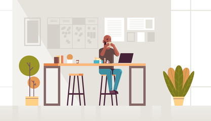sick businessman blowing nose with handkerchief african american guy sitting at workplace using laptop man having flu sneeze illness concept modern office interior full length horizontal vector