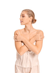 Obraz premium Beautiful young woman in pajamas on white background