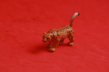 plastic toy with leopard shape in color background