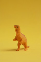 plastic toy with dinosaur shape in color background