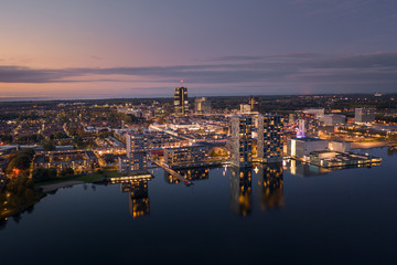 Almere city center illuminated at dusk. Aerial view.