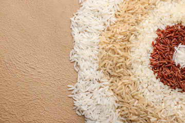 Different raw rice on color background