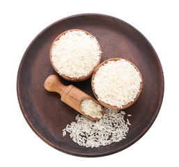 Bowls and scoop with raw rice on white background
