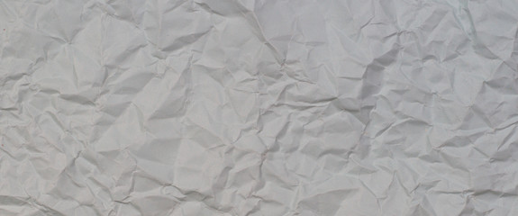 Light grey crumpled wrinkled paper texture background