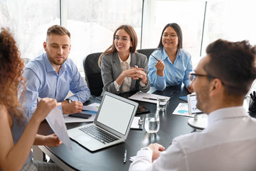 Colleagues discussing issue at business meeting in office