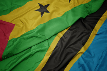 waving colorful flag of tanzania and national flag of sao tome and principe .