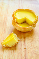 side view fresh egg tart with a quarter cut out close up