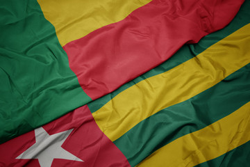 waving colorful flag of togo and national flag of benin.