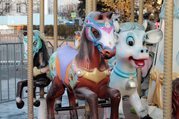 Fototapeta na wymiar Bright carousel in the city square.