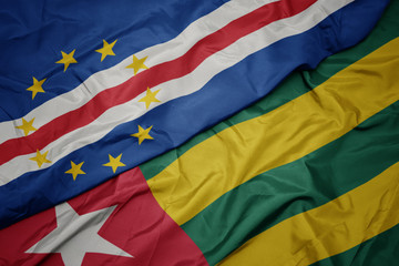 waving colorful flag of togo and national flag of cape verde.