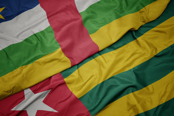 waving colorful flag of togo and national flag of central african republic.
