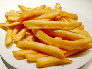 French fries on a white plate for background.