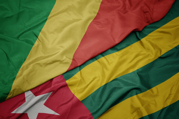 waving colorful flag of togo and national flag of republic of the congo.