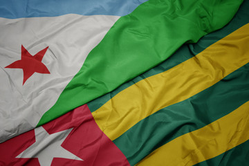 waving colorful flag of togo and national flag of djibouti.