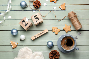 Christmas decor, cookies, coffee and calendar on wooden background