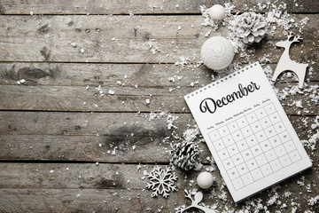 Christmas decor, snow and calendar on wooden background