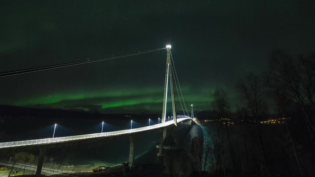 Northern lights, polar light or Aurora Borealis dancing night sky busy bridge in Northern Norway Narvik Halogaland bridge