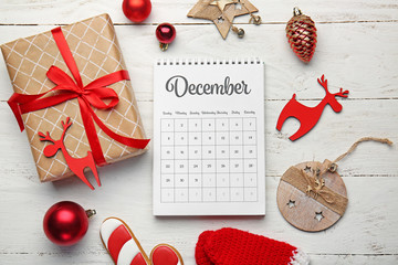 Christmas decor and calendar on wooden background