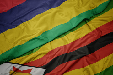 waving colorful flag of zimbabwe and national flag of mauritius.