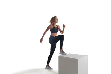 Female athlete running and jumping isolated on white.