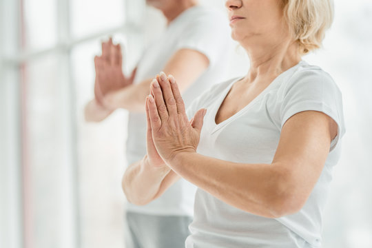 Yoga concept. Cropped image of senior couple practicing yoga in the gym.Health and sport lifestyle.