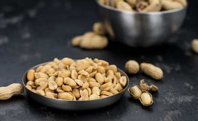 Roasted and salted Peanuts on vintage background