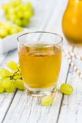 Grape Juice (fresh) as detailed close-up shot, selective focus)