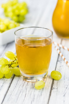 Grape Juice (fresh) as detailed close-up shot, selective focus)