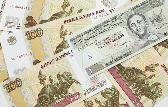 A close up image of a one Ethiopian birr bank note on a background of Russian one hundred ruble bank notes