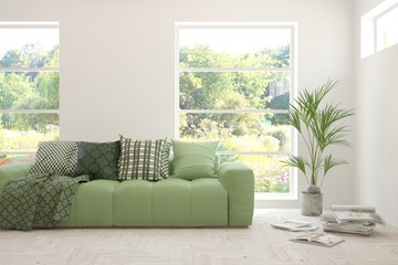 Stylish room in white color with sofa and summer landscape in window. Scandinavian interior design. 3D illustration