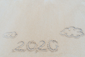 Concept Happy New Year 2020 on the beach Tropical design made in Phuket, Thailand Write the alphabet on the sand background Taken from real locations.
