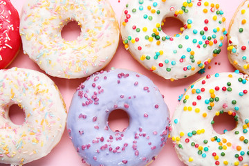 Sweet tasty donuts on color background