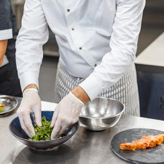 chef cooks a culinary dish in the restaurant kitchen.