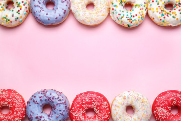 Sweet tasty donuts on color background