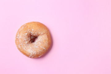 Sweet tasty donut on color background