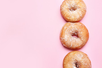 Sweet tasty donuts on color background
