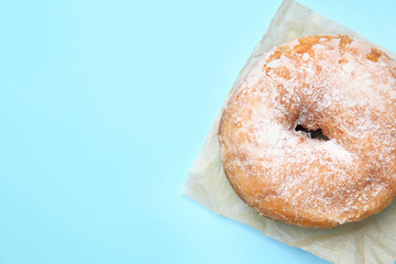 Sweet tasty donut on color background