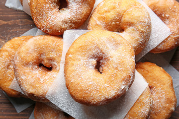 Sweet tasty donuts on wooden background