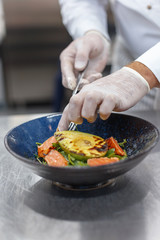 chef cooks a culinary dish in the restaurant kitchen.