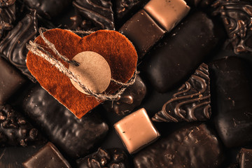 Appetizing food background. Assortment of chocolate handmade candy and red heart card for valentine's day. Chocolate background. 