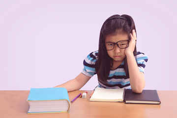 Bored and tired asian student girl doing homework