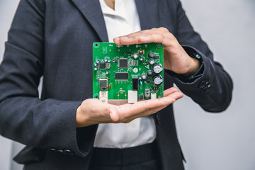 Business people showing printed circuit board new tech computer unit digital device in hand.