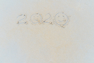 Concept Happy New Year 2020 on the beach Tropical design made in Phuket, Thailand Write the alphabet on the sand background Taken from real locations.