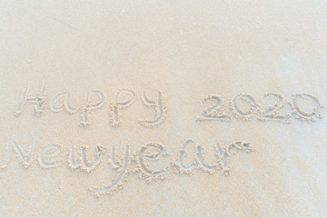 Concept Happy New Year 2020 on the beach Tropical design made in Phuket, Thailand Write the alphabet on the sand background Taken from real locations.