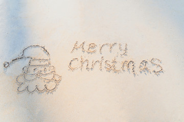 Concept Christmas on the beach Tropical design made in Phuket, Thailand Write the alphabet on the sand background Taken from real locations.