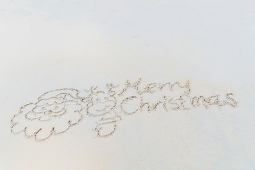 Concept Christmas on the beach Tropical design made in Phuket, Thailand Write the alphabet on the sand background Taken from real locations.