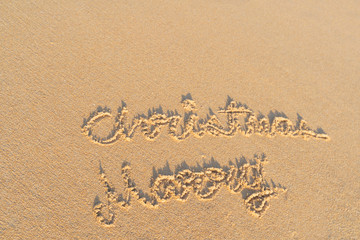 Concept Christmas on the beach Tropical design made in Phuket, Thailand Write the alphabet on the sand background Taken from real locations.