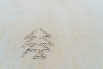 Concept Christmas on the beach Tropical design made in Phuket, Thailand Write the alphabet on the sand background Taken from real locations.